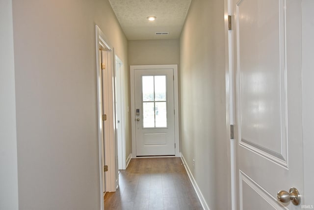 4764 Chelmsford Dr, Newburgh, IN 47630 - doorway to outside with dark wood finished floors and a textured ceiling