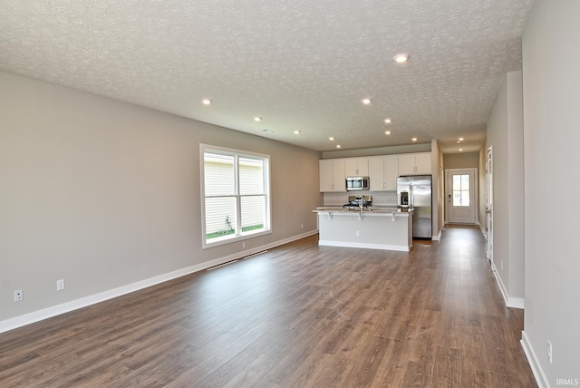 4764 Chelmsford Dr, Newburgh, IN 47630 - unfurnished living room with dark wood finished floors, recessed lighting, and a textured ceiling