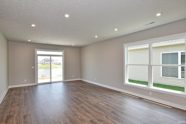 4764 Chelmsford Dr, Newburgh, IN 47630 - empty room with dark wood-style floors, a textured ceiling, and recessed lighting
