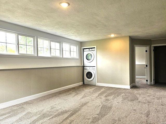 6711 Trier Rd, Fort Wayne, IN 46815 - laundry room with stacked washer / drying machine, carpet floors, and a textured ceiling