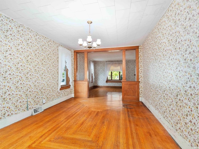 314 N Chauncey St, Columbia City, IN 46725 - unfurnished dining area featuring wallpapered walls, a chandelier, and parquet flooring