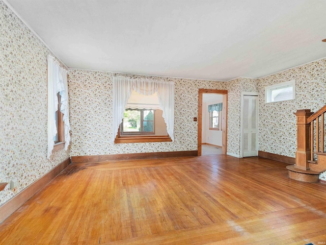 314 N Chauncey St, Columbia City, IN 46725 - spare room featuring wallpapered walls, wood-type flooring, and stairway