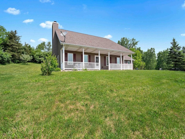 17723 Auburn Rd, Huntertown, IN 46748 - view of front facade with covered porch, a chimney, and a front lawn