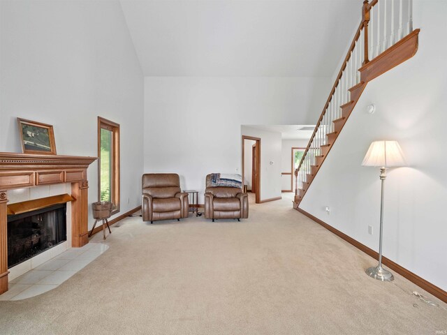 17723 Auburn Rd, Huntertown, IN 46748 - living area featuring high vaulted ceiling, light colored carpet, stairs, and a fireplace