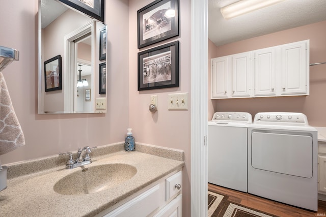 4501 N Wheeling Ave Unit 12-5, Muncie, IN 47304 - bathroom with washer and dryer, vanity, and wood finished floors