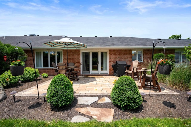 4501 N Wheeling Ave Unit 12-5, Muncie, IN 47304 - back of house featuring brick siding and a patio
