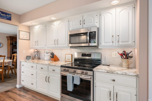 4501 N Wheeling Ave Unit 12-5, Muncie, IN 47304 - kitchen with stainless steel appliances, white cabinets, dark wood-style flooring, tasteful backsplash, and recessed lighting
