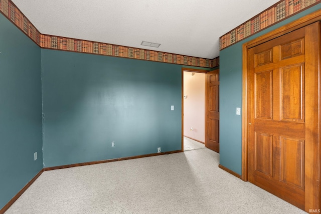 10028 Winding Shores Dr, New Haven, IN 46774 - carpeted spare room featuring baseboards and a textured ceiling