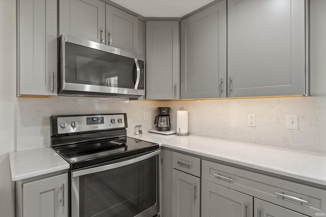 115 N Varsity Dr, South Bend, IN 46615 - kitchen featuring stainless steel appliances, gray cabinetry, and tasteful backsplash