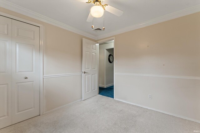 115 N Varsity Dr, South Bend, IN 46615 - unfurnished bedroom featuring carpet, ornamental molding, a ceiling fan, and a closet