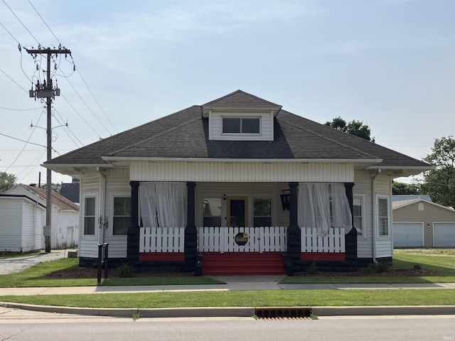 20 N Meridian St, Redkey, IN 47373 - bungalow-style house with covered porch, roof with shingles, a front lawn, and a detached garage