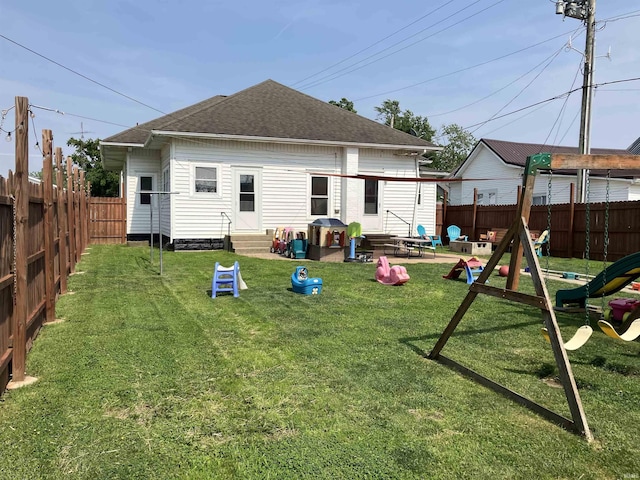 20 N Meridian St, Redkey, IN 47373 - rear view of house featuring entry steps, a fenced backyard, roof with shingles, and a patio area