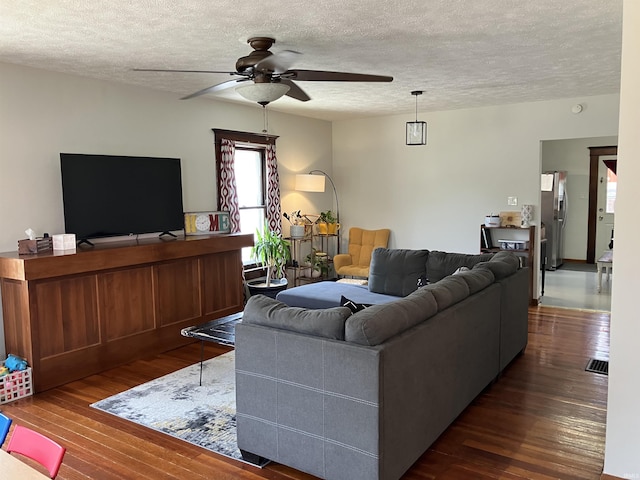 20 N Meridian St, Redkey, IN 47373 - living room featuring ceiling fan, a textured ceiling, and dark wood-style flooring