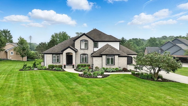 12733 Covington Manor Farms Rd, Fort Wayne, IN 46814 - french country style house with a front yard, brick siding, and a shingled roof