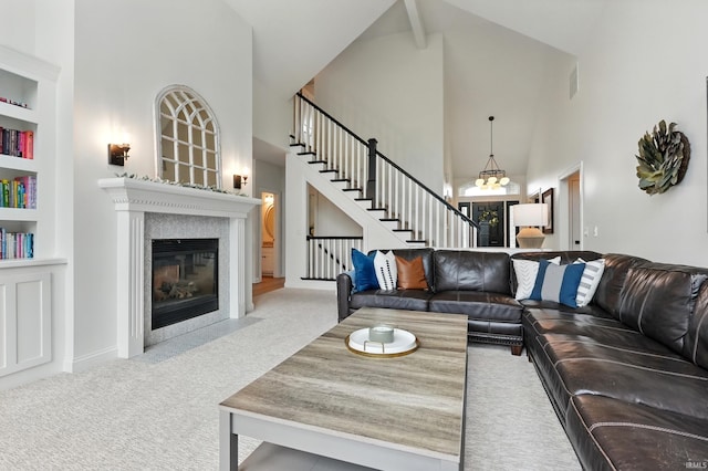 12733 Covington Manor Farms Rd, Fort Wayne, IN 46814 - living room with carpet flooring, high vaulted ceiling, stairs, a fireplace with flush hearth, and built in features
