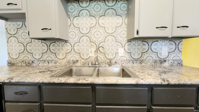 406 James St, Butler, IN 46721 - kitchen with white cabinetry, light countertops, and tasteful backsplash