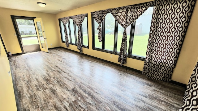 406 James St, Butler, IN 46721 - spare room featuring wood finished floors and baseboards