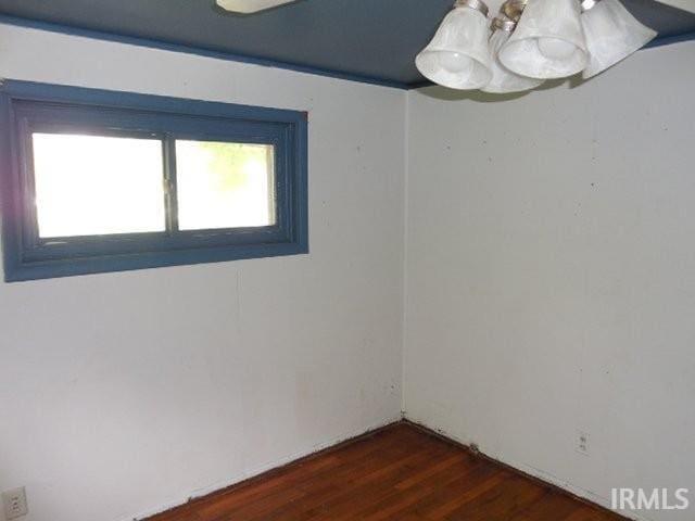 408 E Water St, Centerville, IN 47330 - unfurnished room with dark wood-style floors and a chandelier
