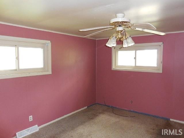 408 E Water St, Centerville, IN 47330 - unfurnished room featuring healthy amount of natural light, ceiling fan, carpet floors, and ornamental molding