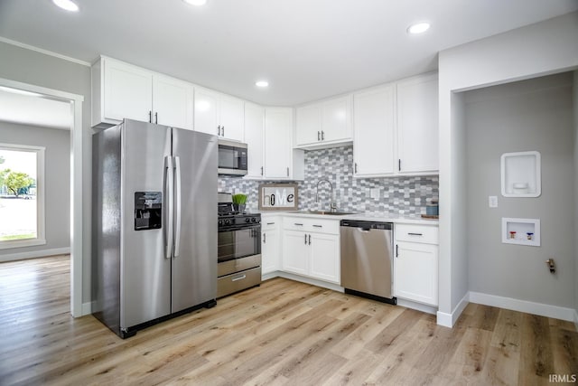1004 Shenandoah Dr, Lafayette, IN 47905 - kitchen with appliances with stainless steel finishes, decorative backsplash, light wood finished floors, white cabinetry, and recessed lighting