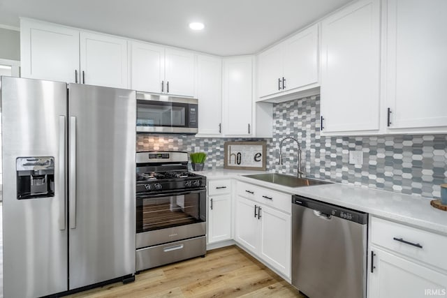1004 Shenandoah Dr, Lafayette, IN 47905 - kitchen with stainless steel appliances, light countertops, white cabinetry, tasteful backsplash, and recessed lighting