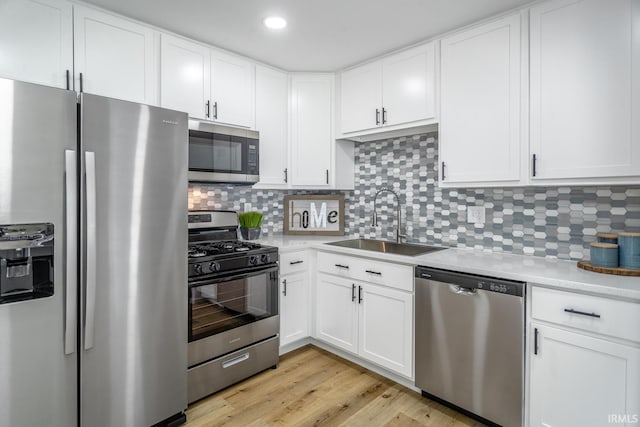 1004 Shenandoah Dr, Lafayette, IN 47905 - kitchen featuring stainless steel appliances, light countertops, white cabinetry, decorative backsplash, and recessed lighting