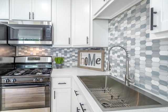 1004 Shenandoah Dr, Lafayette, IN 47905 - kitchen with stainless steel microwave, black gas range, tasteful backsplash, white cabinets, and light countertops