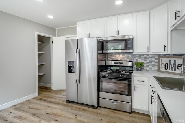 1004 Shenandoah Dr, Lafayette, IN 47905 - kitchen featuring appliances with stainless steel finishes, light countertops, white cabinetry, decorative backsplash, and recessed lighting