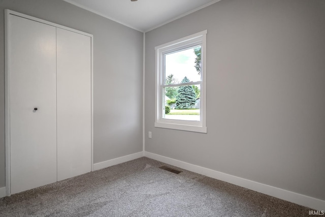 1004 Shenandoah Dr, Lafayette, IN 47905 - unfurnished bedroom featuring carpet floors, ornamental molding, and a closet