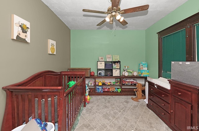 19252 Cleveland Rd, South Bend, IN 46637 - bedroom with a nursery area, ceiling fan, and a textured ceiling