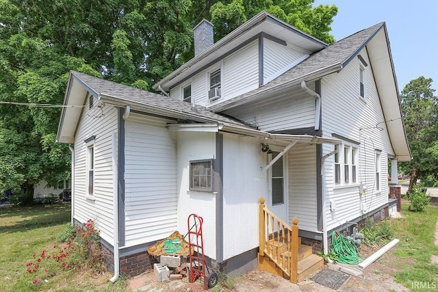 19252 Cleveland Rd, South Bend, IN 46637 - view of front of property with entry steps, a chimney, and a shingled roof