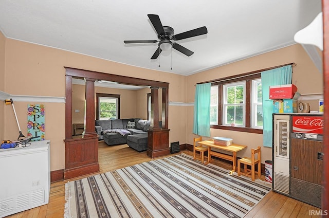19252 Cleveland Rd, South Bend, IN 46637 - living room with ornate columns, hardwood / wood-style flooring, and a ceiling fan