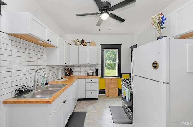 19252 Cleveland Rd, South Bend, IN 46637 - kitchen with freestanding refrigerator, stainless steel gas range oven, ceiling fan, white cabinets, and decorative backsplash