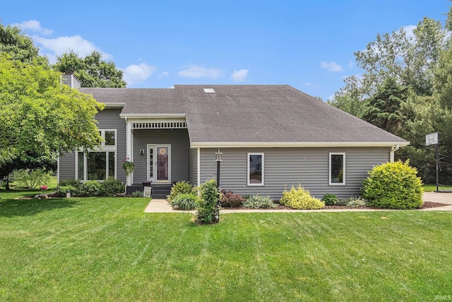 51790 Sulkey Ct, Granger, IN 46530 - view of front of house featuring a front yard, a chimney, and roof with shingles