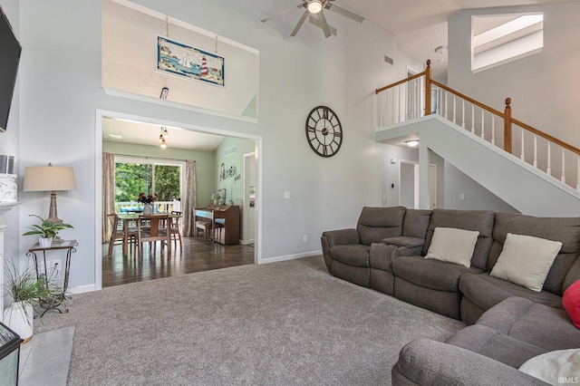 51790 Sulkey Ct, Granger, IN 46530 - living area featuring carpet flooring, a towering ceiling, ceiling fan, and stairs