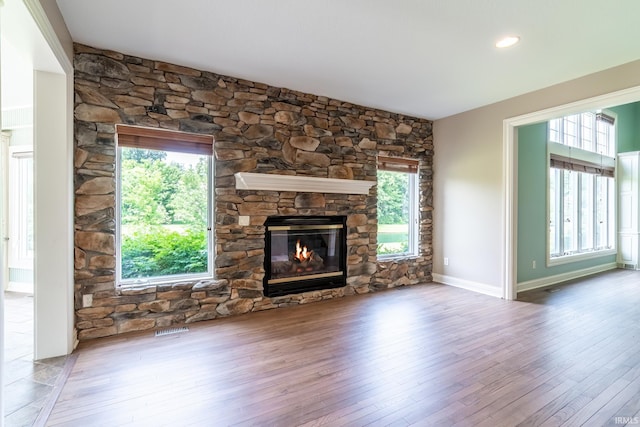 3328 Tarrant Springs Trl, Fort Wayne, IN 46804 - unfurnished living room with a fireplace, wood finished floors, and healthy amount of natural light