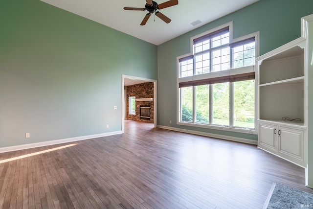 3328 Tarrant Springs Trl, Fort Wayne, IN 46804 - unfurnished living room with a towering ceiling, a ceiling fan, wood finished floors, and a fireplace