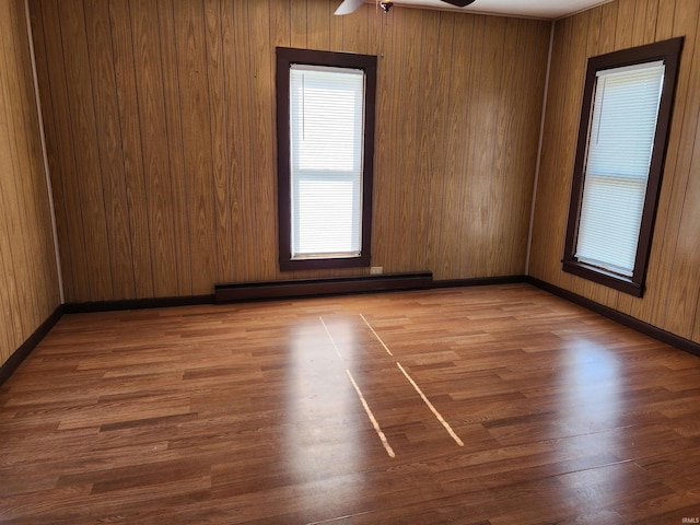 317 E Main St, Berne, IN 46711 - unfurnished room with a baseboard heating unit, ceiling fan, and wood finished floors