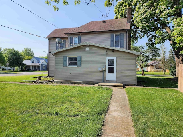 317 E Main St, Berne, IN 46711 - view of front of property featuring a chimney and a front yard