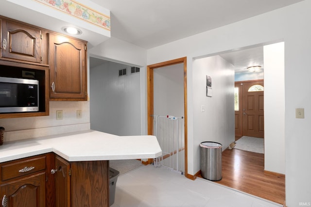 3506 Mark Ct, Lafayette, IN 47905 - kitchen featuring stainless steel microwave, light countertops, and a peninsula
