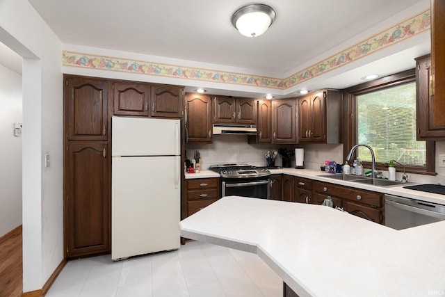 3506 Mark Ct, Lafayette, IN 47905 - kitchen featuring appliances with stainless steel finishes, under cabinet range hood, dark brown cabinets, and light countertops