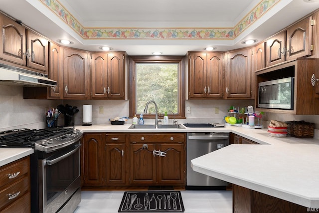 3506 Mark Ct, Lafayette, IN 47905 - kitchen featuring stainless steel appliances, under cabinet range hood, light countertops, and a peninsula