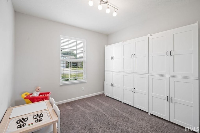 938 Sand Walk Ln, Kokomo, IN 46902 - bedroom with dark colored carpet and track lighting