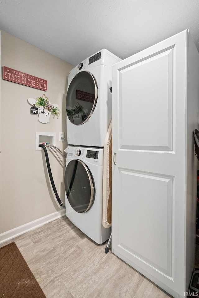 938 Sand Walk Ln, Kokomo, IN 46902 - washroom with estacked washer and dryer and light wood-type flooring