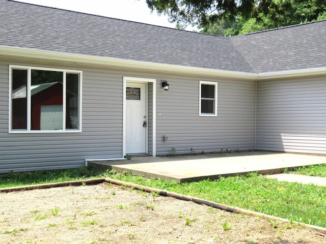 10239 State Road 26 E, Lafayette, IN 47905 - property entrance with roof with shingles and a patio area
