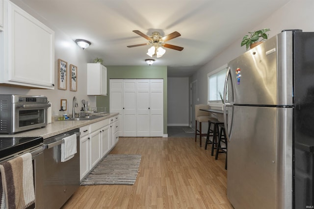 3623 Rexford Dr, South Bend, IN 46615 - kitchen featuring appliances with stainless steel finishes, light wood-style floors, and a ceiling fan