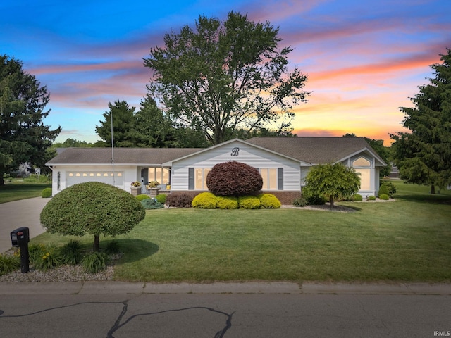 106 River Cove Ln, North Manchester, IN 46962 - ranch-style home with an attached garage, concrete driveway, and a front lawn