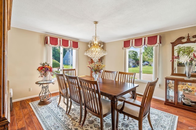106 River Cove Ln, North Manchester, IN 46962 - dining space with a chandelier, dark wood-style floors, ornamental molding, and a textured ceiling