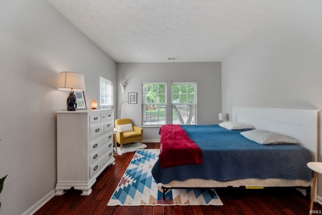 1009 Elliott St, Lafayette, IN 47905 - bedroom with dark wood-style flooring and a textured ceiling