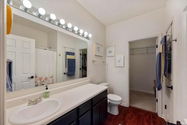 1009 Elliott St, Lafayette, IN 47905 - bathroom featuring vanity, wood finished floors, a spacious closet, and curtained shower